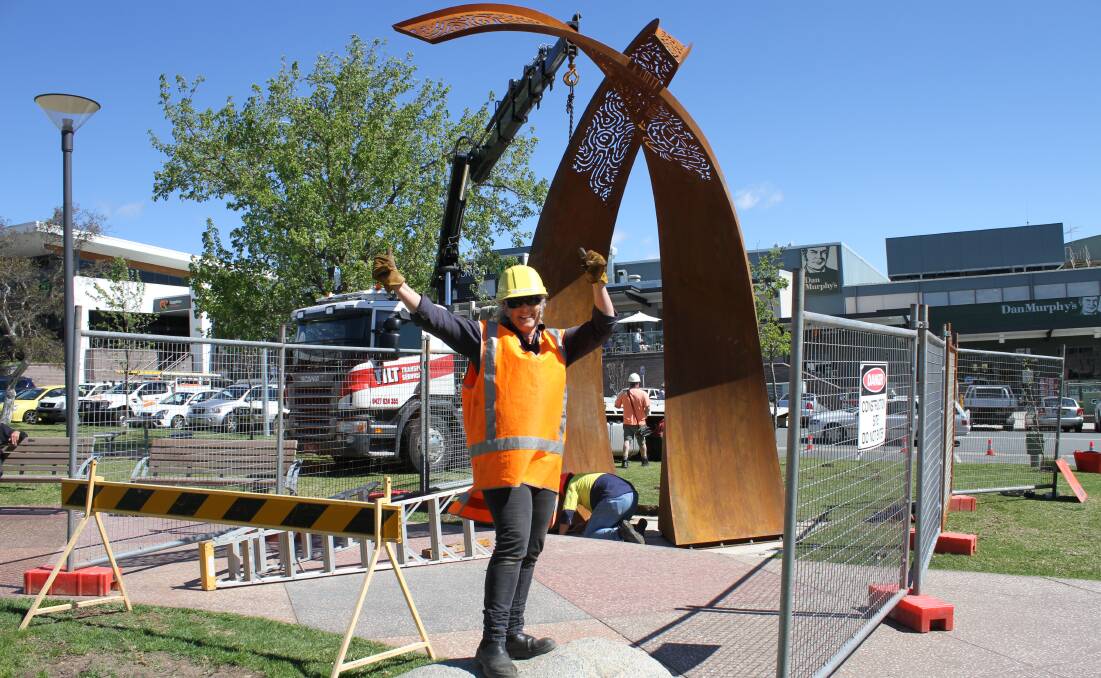 Two Rivers: Pambula artist Jen Mallinson celebrates her work being put in place in Littleton Gardens last Thursday. Picture: Alasdair McDonald.