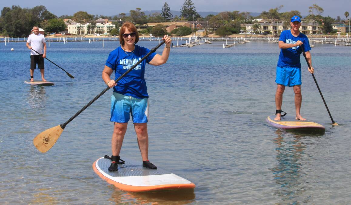 Young at heart: Liz Smallwood and Steve Goodchild try their hand at Stand Up Paddleboarding with some instructions from Stave Farley of Merimbula Stand Up Paddle Lessons and Tours. Picture: Melanie Leach