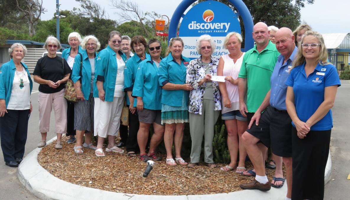 Delighted: Pambula Auxiliary members happily accept a $1,180 donation from Victorian visitors Louise and Peter Mayall with Pambula Discovery Park manager Laurie O'Shea. 