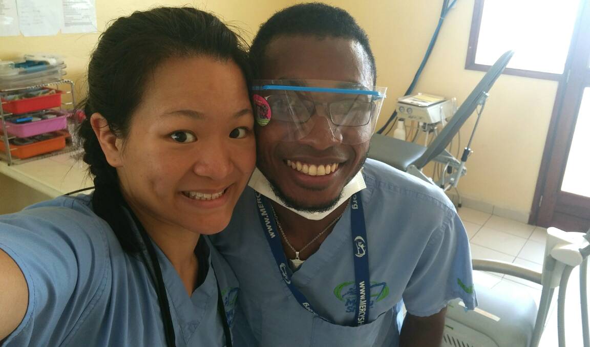 Share a smile: Merimbula Beach Street dentist Dr Sarah Lam with her local assistant, Narcisse, while she was volunteering aboard the Africa Mercy in Madagascar. 
