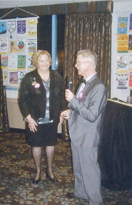 LIONS: Outgoing president Ric Vanderbom presenting the president’s badge, gong and gavel to Robyn Bedford. 
