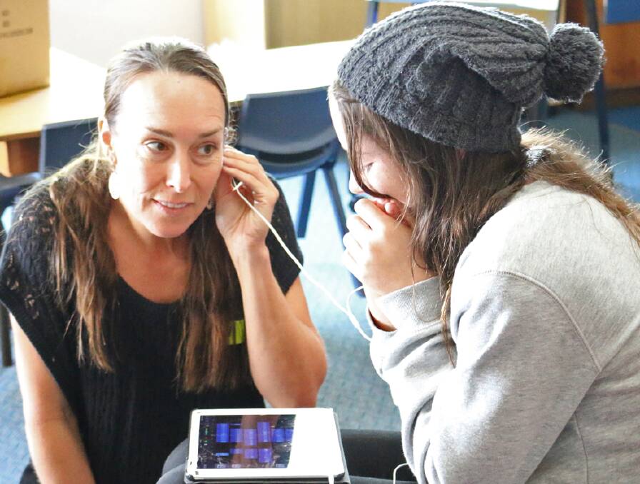 Film tutor Toni Houston listens in to an original soundtrack made by student Georgina Marks at the 2016 Film School in Pambula.