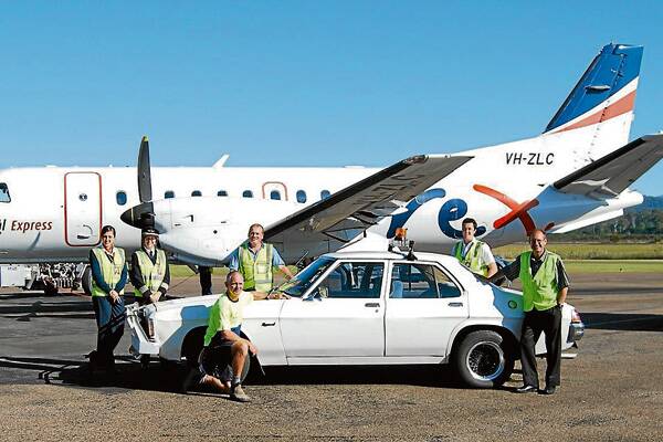 • Rex Airlines representatives, left, Ricky Holt, Merimbula Bus Lines’ Paul Pincini, Merimbula Air Services’ Ryan Campbell and Bryan Hammond with their 1978 Hz Holden and their major sponsor vehicles, including a Bobbins Transport truck. 