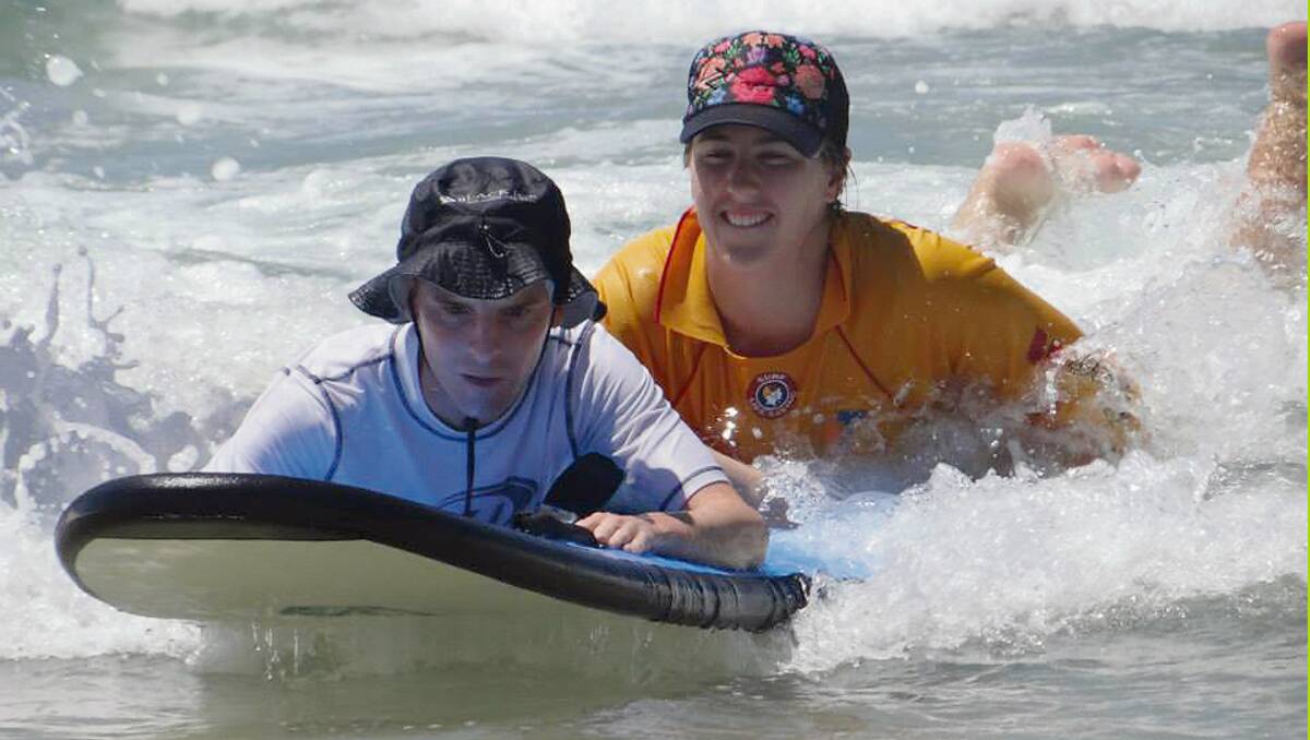 • Special Nipper cadet Ross  (left) catches a wave with instructor Kamilla Grubesic for the first session of the season. Photo: Ann Wright.