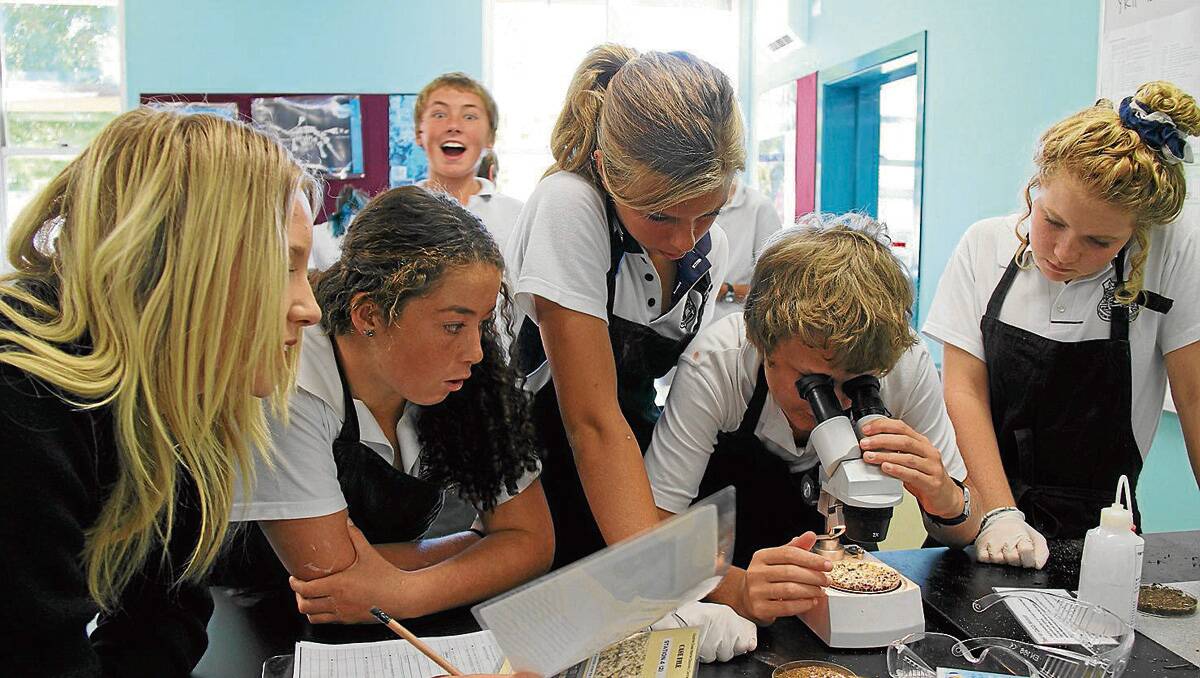 EMHS Year 8 students Kristal Sellen, Zali Kelly, Ebony Pointon, James Body and Shania Closter (with Luke Edgerton in the background) working in a team to determine the amount of calcium carbonate in the sand samples.