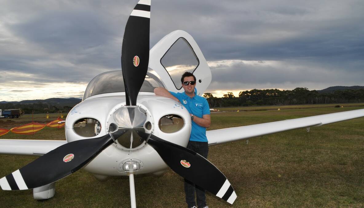 Ryan Campbell at Merimbula Airport with the Cirrus RS22 aircraft in which he will fly around the world.