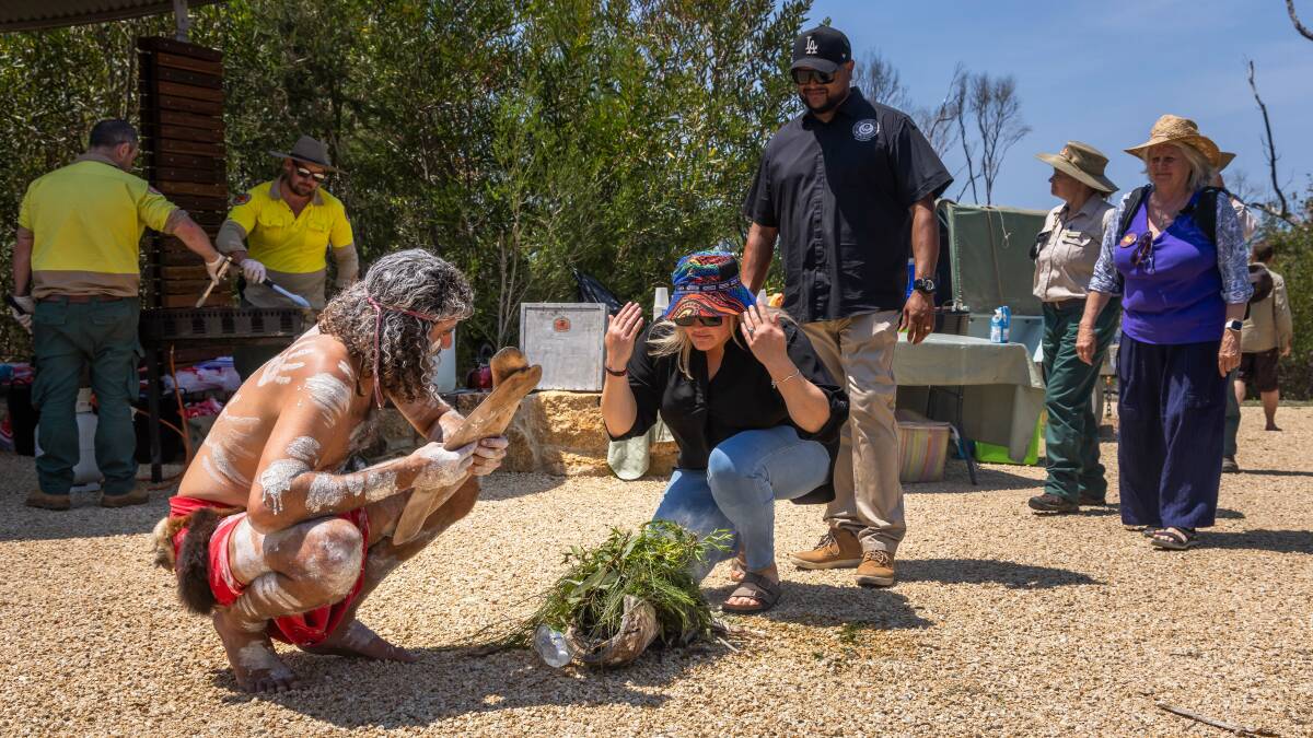 Nathan Lygon conducts a smoking ceremony at the Beowa National Park Renaming Celebration - with Alison and Neville Simpson taking in the smoke blessing. Picture by David Rogers