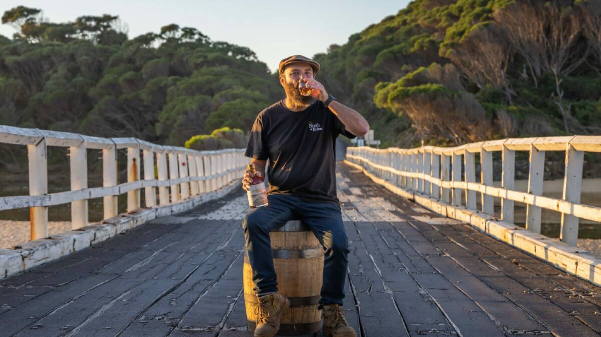 Gavin Hughes from North of Eden at Cuttagee Bridge on the Far South Coast taking a sip of his new gin dubbed The Bridge. Photo: David Rogers 
