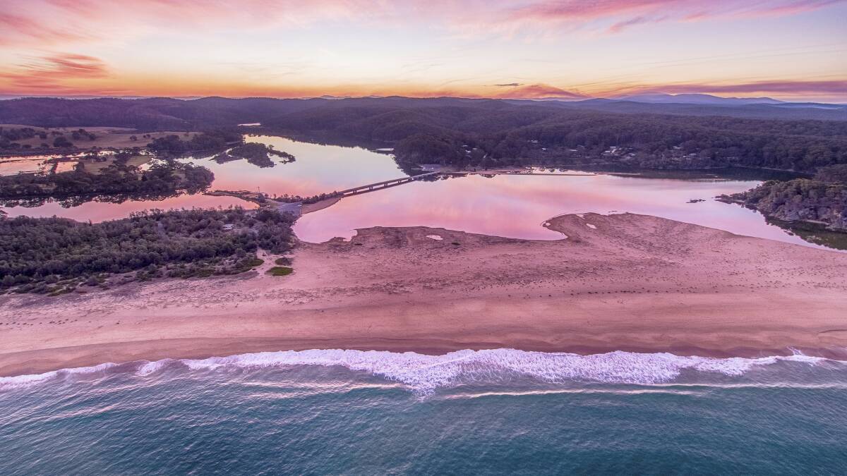 Sun setting over the Bega River and Tathra Beach, Tathra. Picture: Destination NSW
