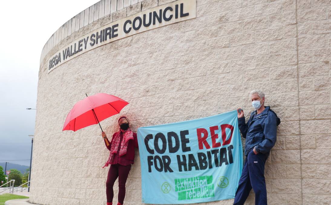 Two protestors from Extinction Rebellion holding up a sign that reads CODE READ FOR HABITAT in front on Bega Valley Shire Council on Wednesday October 20. Picture: Ellouise Bailey