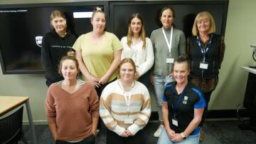 Students currently completing a Certificate IV in Ageing Support at the University of Wollongong College in partnership with Sapphire Coast Community Aged Care are (back, from left) Eliza O'Dell, Mia Jones, Tatjana Sewell, Ginny Tooth, Trainer Debra Fabris (front) Elizabeth Martinelli, Daisy Goldberg-Otton, and trainer Jade Anderson. Photo: Ellouise Bailey 