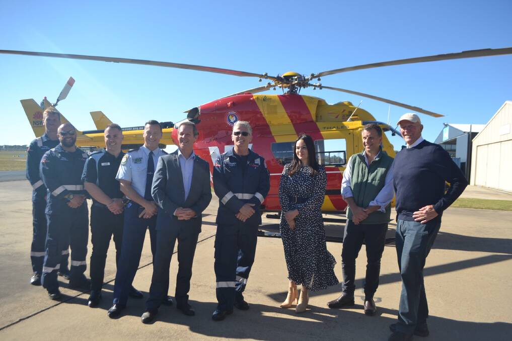 Representatives from SLSA, South Coast Police, Westpac and Member for Bega Andrew Constance unveil the upgraded chopper. 