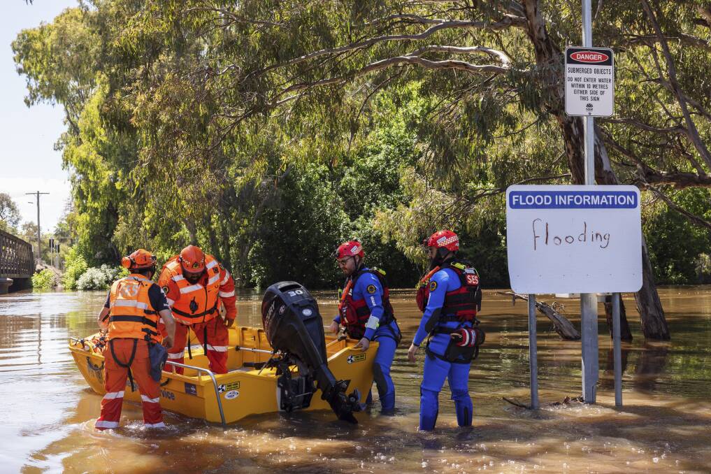 NSW SES flood rescue operators launch a flood boat off the banks of the Lachlan River on November 17, 2021. Major flood warnings are still in place for parts of the Lachlan River. 