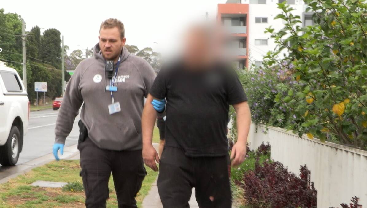 Police arrest a 49-year-old man at the Merrylands property. Picture via NSW Police