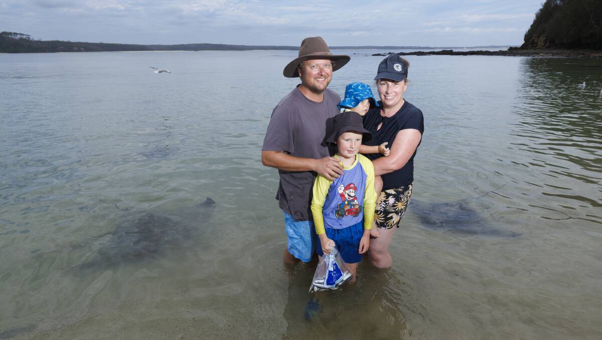 The Johnston family, Darryl, Ally, Riley, 7, Levi, 2, enjoying a day surrounded by wild stingrays at Washerwoman's Beach near Bendalong village. Picture by Keegan Carroll
