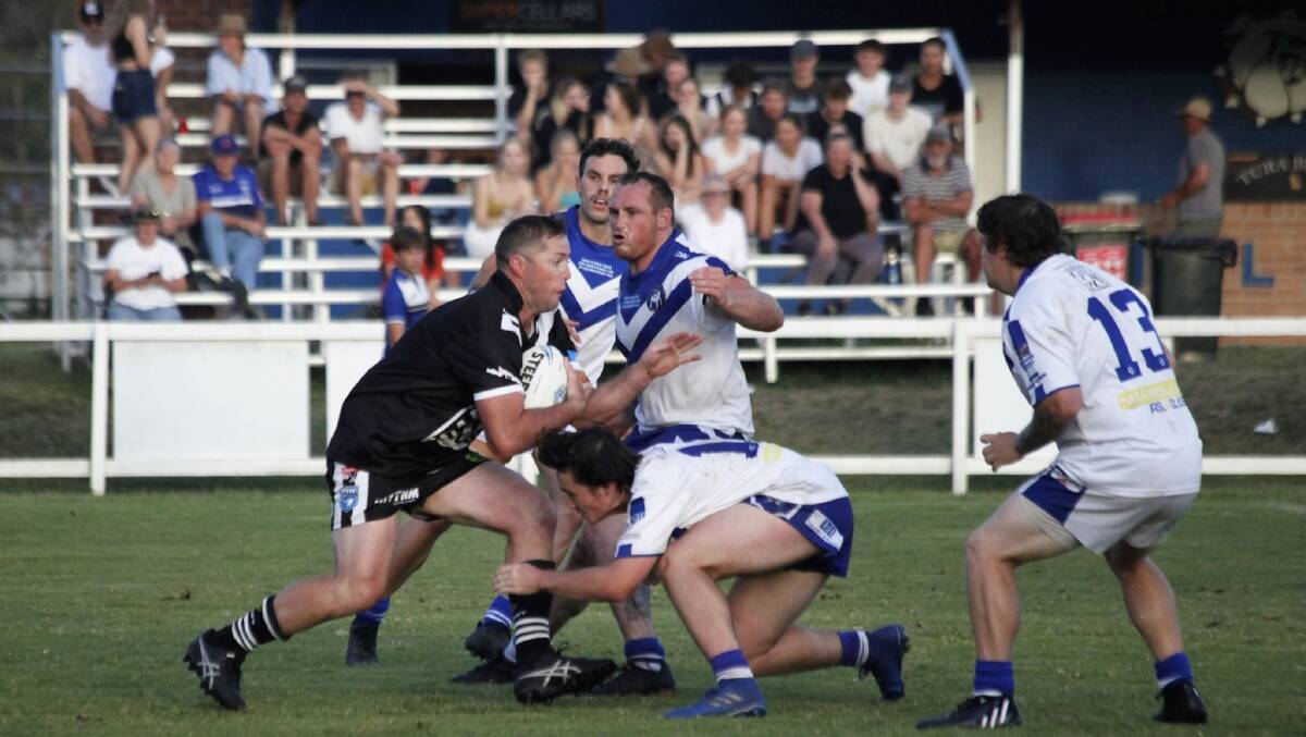 The Bulldogs swarming the Cooma Stallions in a pre-season match in Pambula last month. Picture by Melissa Gray