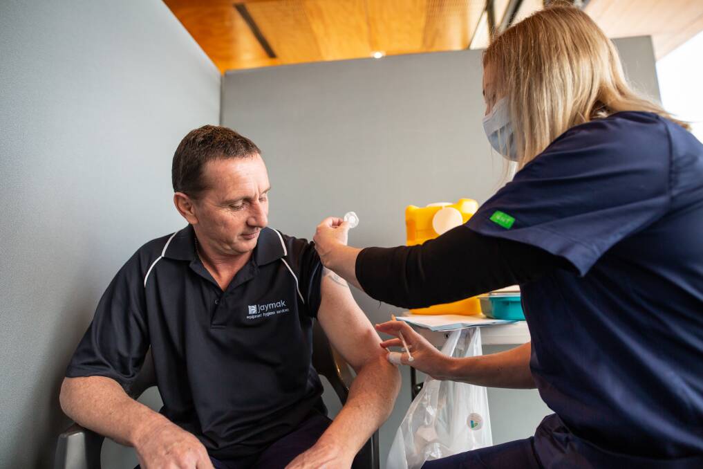Steven Maxwell, from Port Sorell, and Melissa Chifley, Regional Clinical Nurse Consultant at the Devonport Surf Life Saving Club Vaccine Clinic. Picture by Eve Woodhouse.