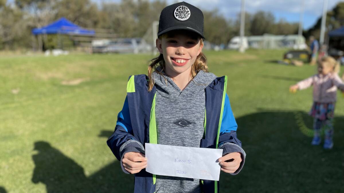 Jesse Rorison, 10 years old, is elated when his raffle ticket secured the winning piglet and $200. Picture by James Parker