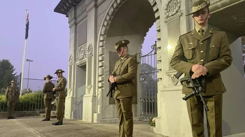 Bega's Anzac Day dawn service catafalque party rest on arms under the Soldiers Memorial Gates. Picture by Ben Smyth