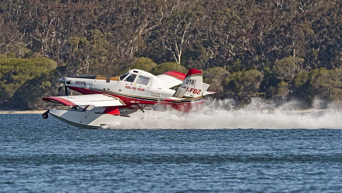 One of the five Air Tractor AT-802F Fire Boss amphibian aircraft that have been brought in to assist with local fires refills in Wallagoot Lake. Picture: Kim Armstrong.