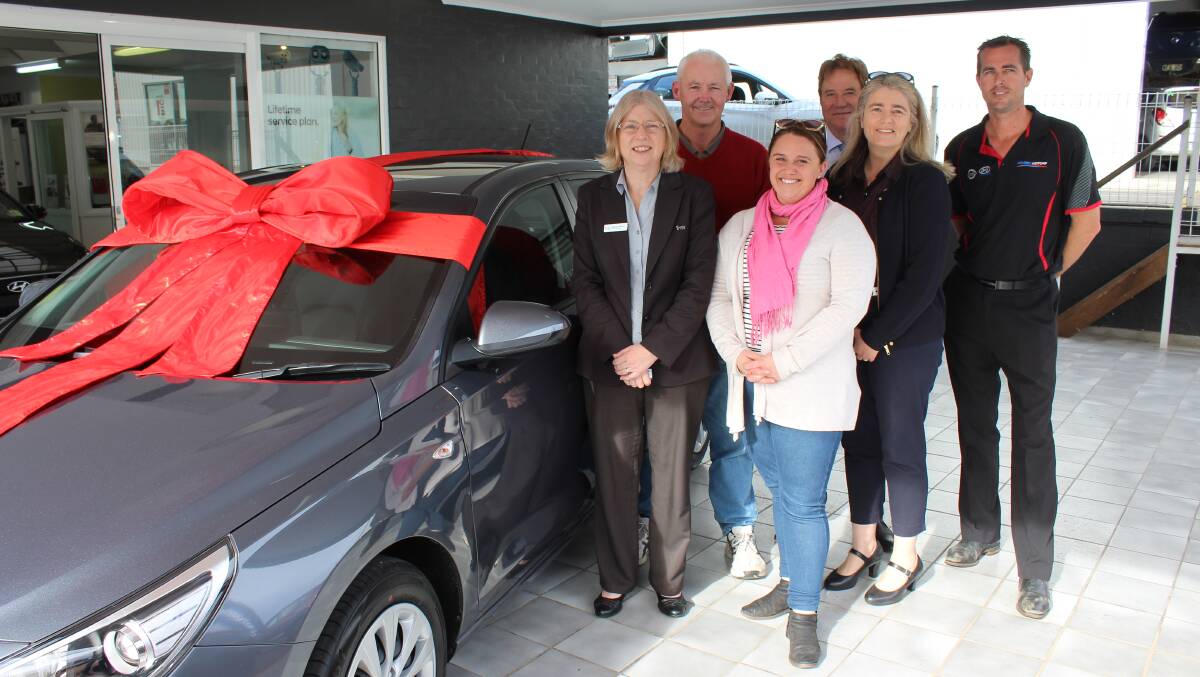 Michelle Milsom (left) and husband Dennis collect their Band Together raffle prize - a new car - from Leo Papalia, Jess Ryan, Gudrun Stylianou and Robert Motbey.
