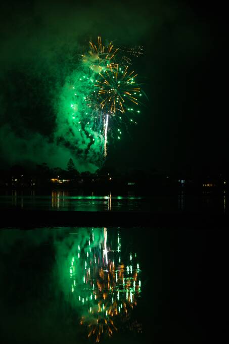 WHAT A BLAST: Midnight fireworks over Merimbula lit up the night sky - and the lake. Photo: Peter Whiter, DoubleTake photography