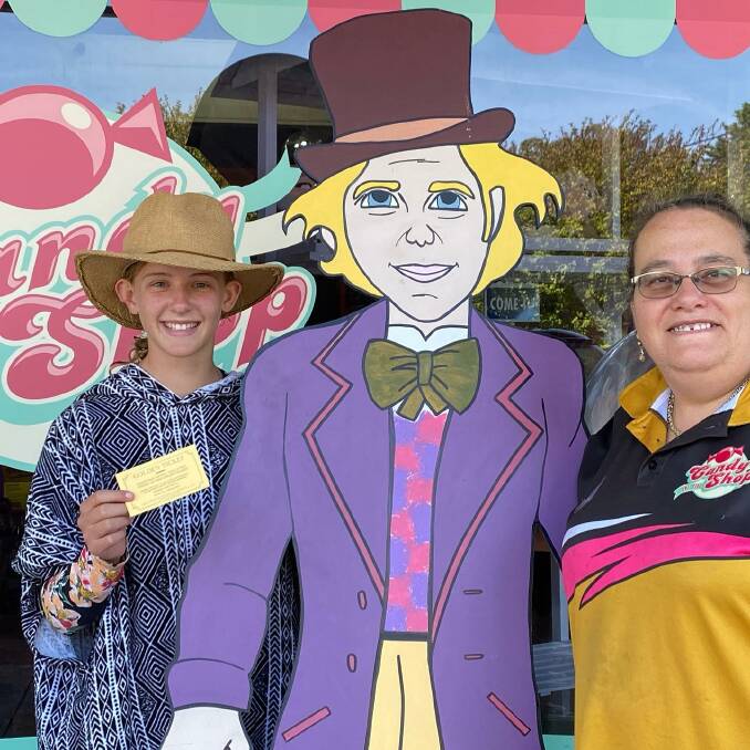 MAGICAL: A happy visitor with the first of three Wonka Bar "golden tickets" found in Rita Palmer's One Stop Candy Shop in Pambula. Photo supplied