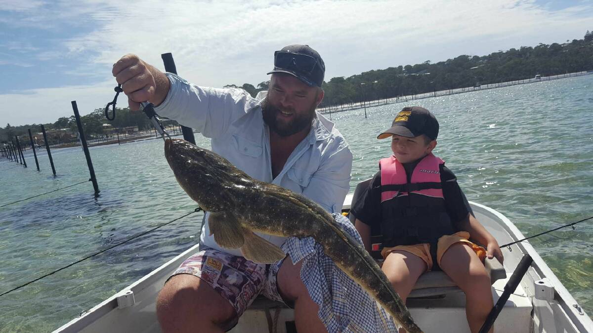 CATCH: While holidaying in Merimbula, Josh Bromilow and son Eli, of Melbourne, caught this 91cm flathead after a 25-minute chase, assisted by skipper Max Klemke.
