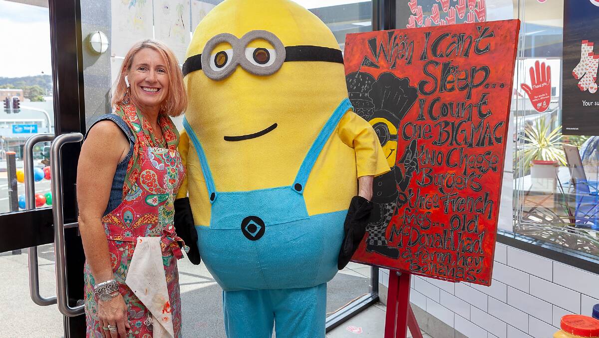 FUN-DRAISER: Sue-Ellen Yates meets a fan of her artwork during the McHappy Day celebrations at Merimbula. Picture: Phillip Hayson