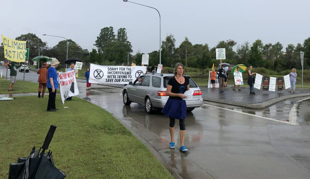 Climate activists from across the region briefly hold up traffic in Bega on Saturday as they continue calling on government to make action of climate change a priority.