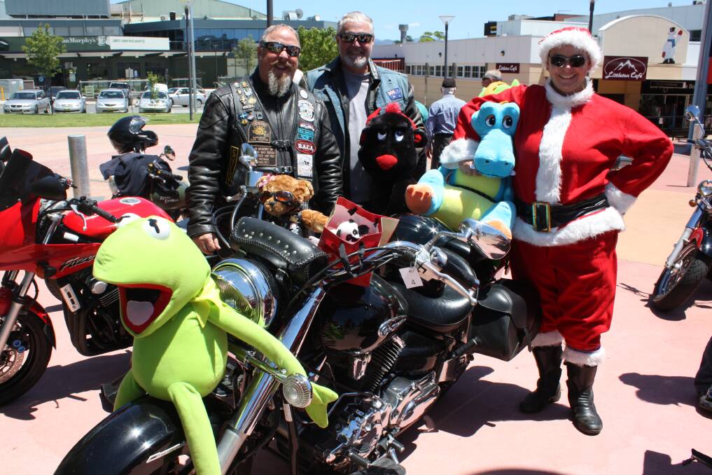 TOY RUN: Motorcyclists Glenn Cotter, Andrew Whittington and Kate Spears arrive in Littleton Gardens bearing gifts for the region's disadvantaged.