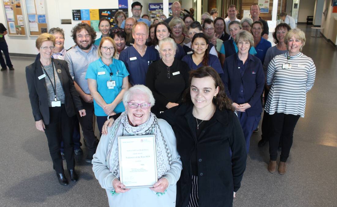 QUALITY CARE: Beryl Harris, with her granddaughter Ella Harris, is congratulated by many of the other staff and volunteers at South East Regional Hospital for a volunteer award presented earlier this year.