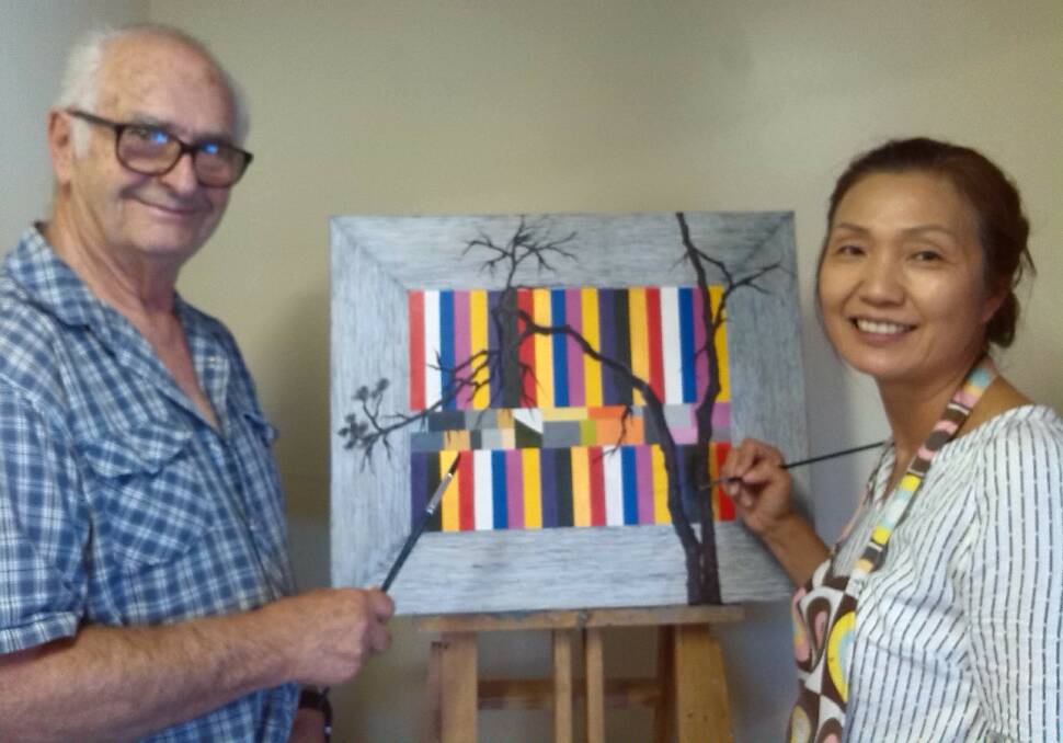Franco Svampa watches as Sangmi Lee puts finishing touches to her exhibition entry.