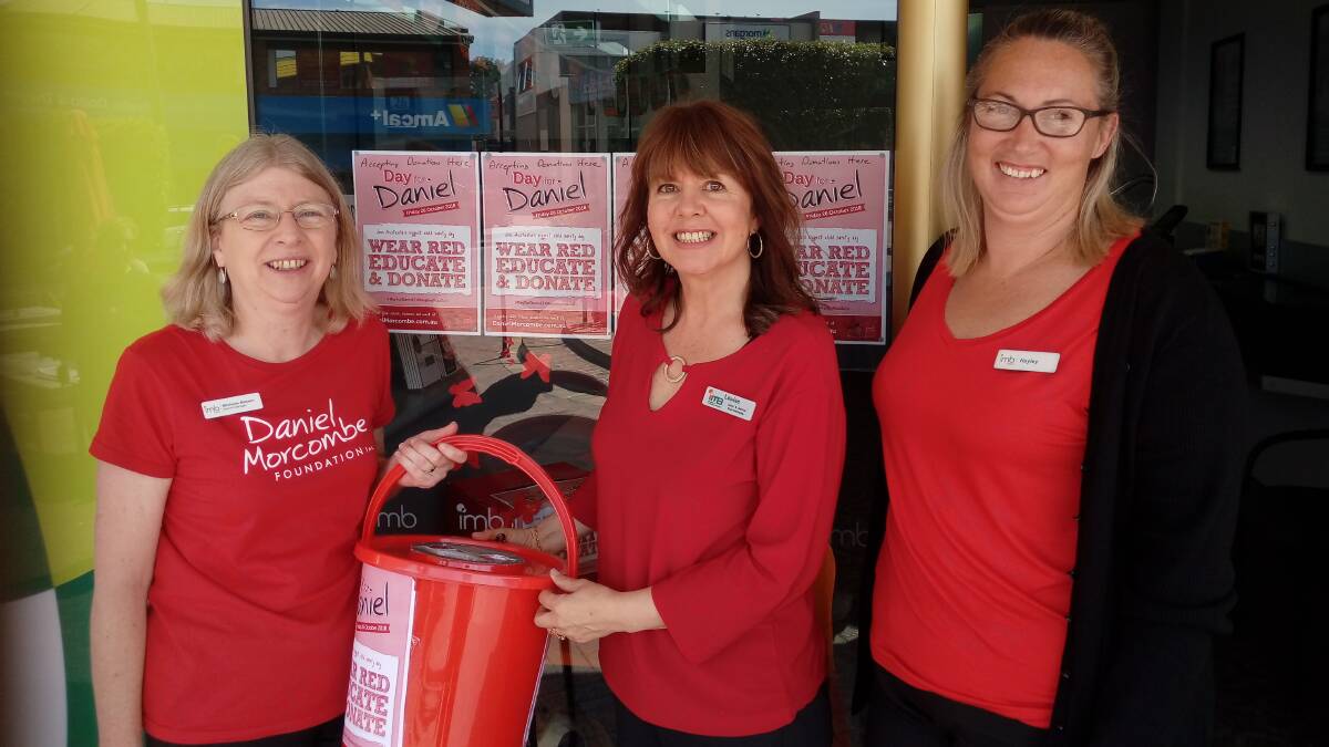Child Safety: The red bucket brigade of IMB Bank Merimbula roamed the streets collecting donations for the Daniel Morcombe Foundation on Friday.