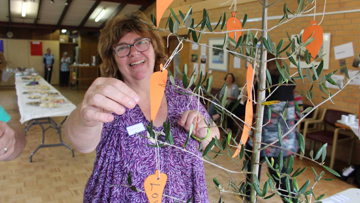 Christine Welsh placing a suggestion to the community on the social inclusions tree.