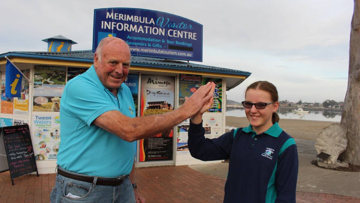 Hi-five: Graeme Mills, 78 and Chelsea Smith, 12, celebrate volunteers week at the Merimbula Visitor Information Centre. 