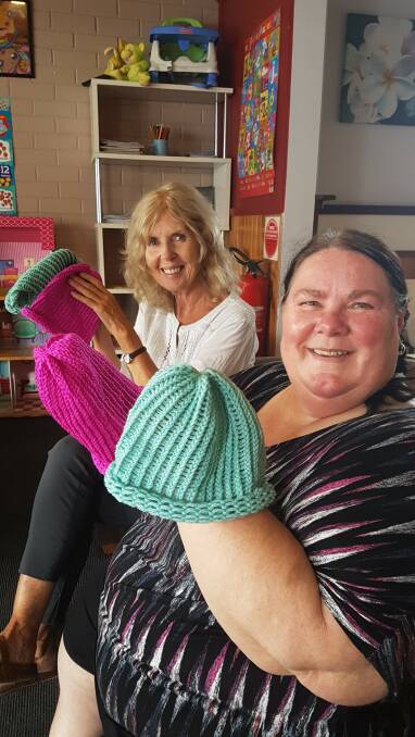  Libby Weir and Margaret Taylor holding up some of the beanies Margaret has made.