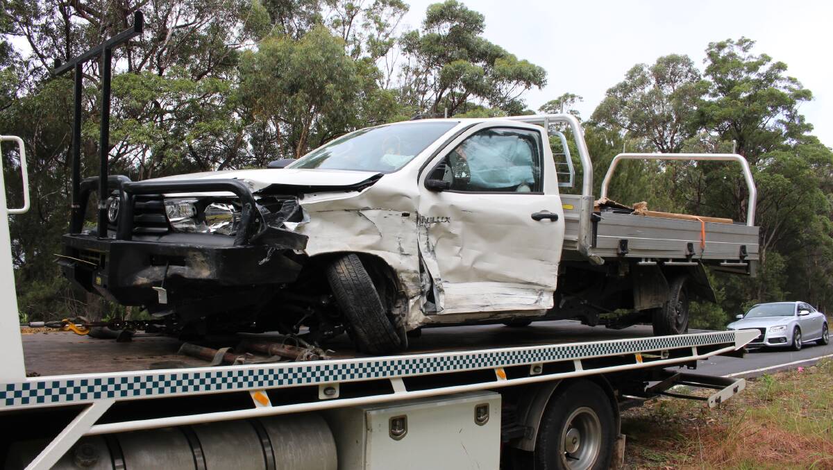 Damaged Hilux on the back of a tow truck.