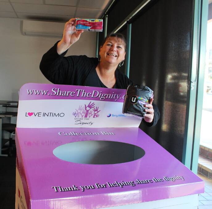 Sandra putting a donation of sanitary products into the Share the Dignity box.