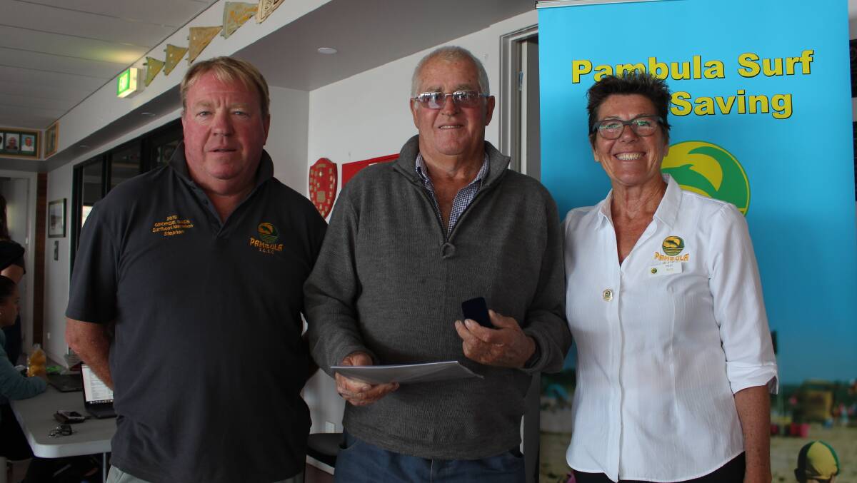 President of Pambula Surf Lifesaving Club Stephen Hodgson and club captain Ann Smith presenting Bill Deveril (centre) with a 50-year long service award.