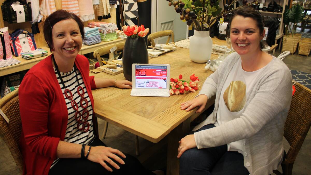 Red and ready: Melissa Pouliot meets with Amanda Twyford at The Hub, one of the businesses hosting an event on Day for Daniel to raise awareness of child safety and funds for the Daniel Morcombe Foundation. Photo: Alana Beitz.