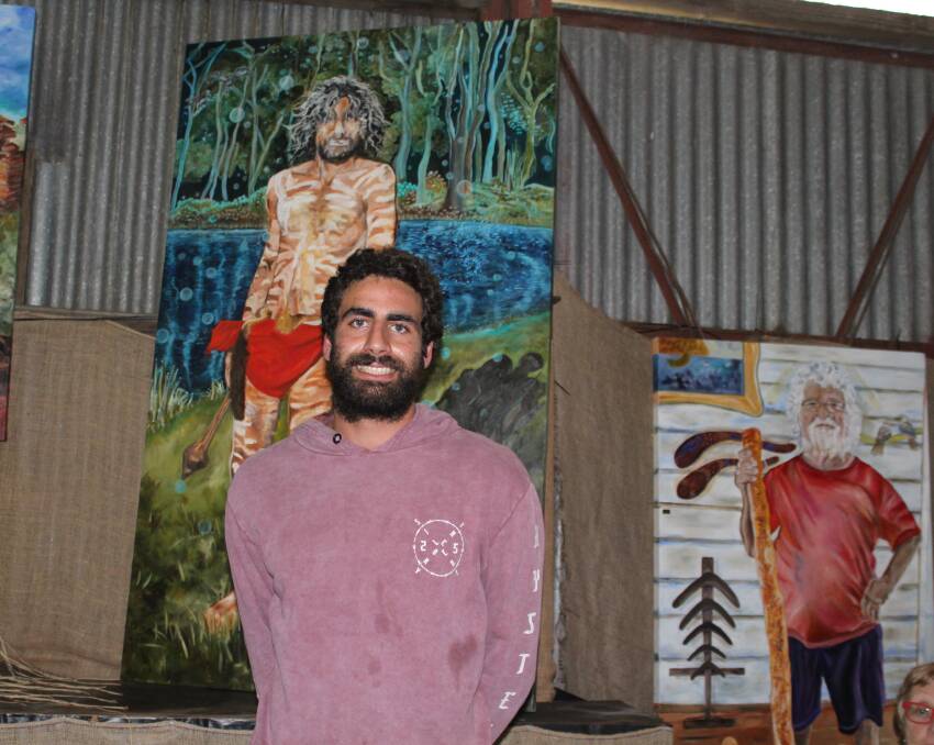 Maningrida Bound: Nathan Lygon stands in front of his portrait painted by Vicki McCredie at the opening of the You'N Me Family of Portraits exhibition at the Apma Gallery in Central Tilba.  