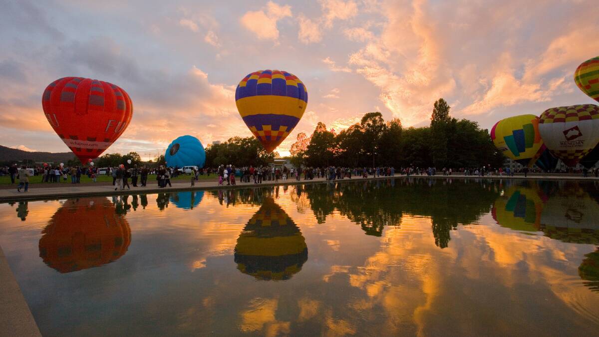 Hot air balloons prepare to take off during the Canberra Balloon Spectacular.
