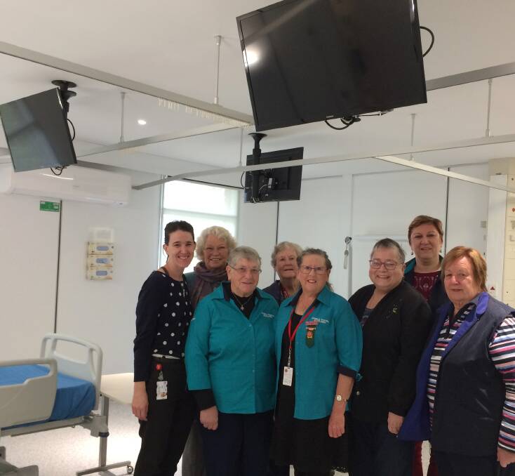 Pambula District Hospital Auxiliary members see the newly installed ceiling TVs in one of the wards which were funded by the auxiliary. Back Kelly Jurd (nurse manager), Wendy Gorton, Barbara J Davy, Anne Bogut with front Maureen Hadley, Shirley Rixon, Ursula Viebcke and Sue Guthrie.
