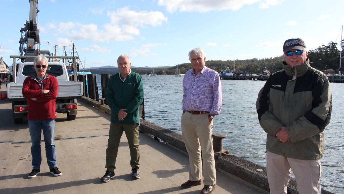 Port Of Eden Marina (POEM) president Robin Arthur, committee member Peter Smith, secretary Dr Rob Bain and committee member Ken Farrell stand with the expected site of the attenuator behind them. 
