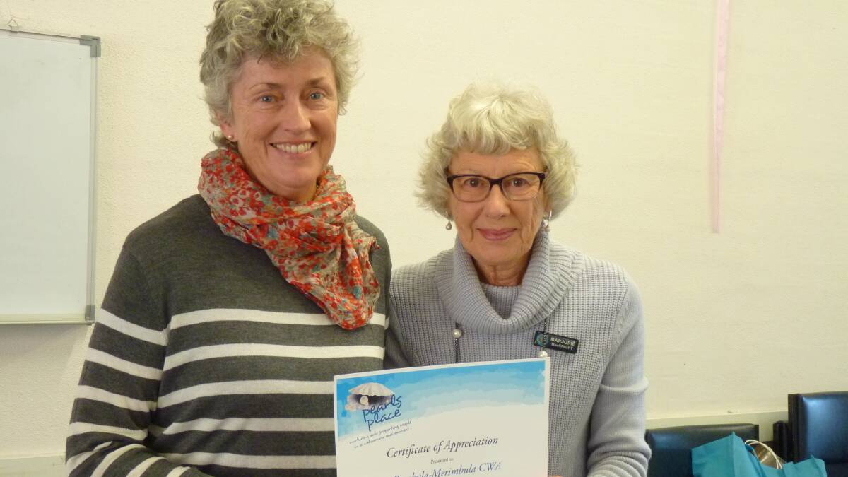 Pambula-Merimbula CWA secretary Marjorie MacKnight accepting a Certificate of Appreciation from Kate Smith, president of the steering committee of Pearls Place.