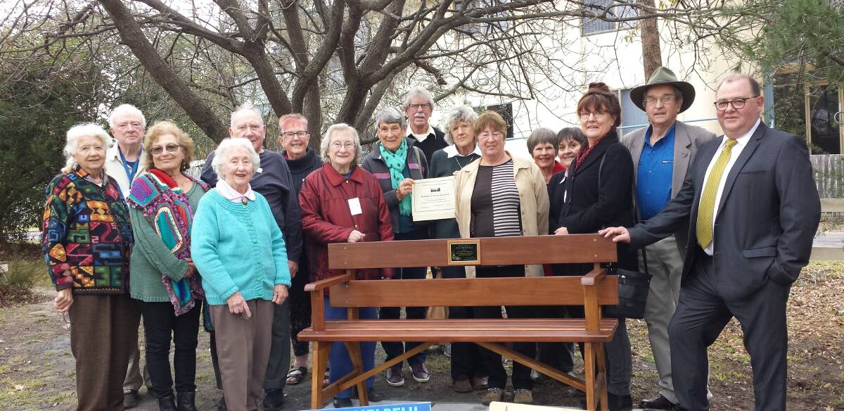 Members from the Old School Museum, Merimbula Garden Club and the Men's Shed with the new seat.