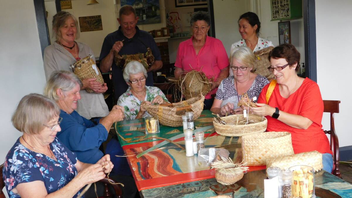 Garden club members get some basket-making tuition from the Wyndham Basket Weavers.