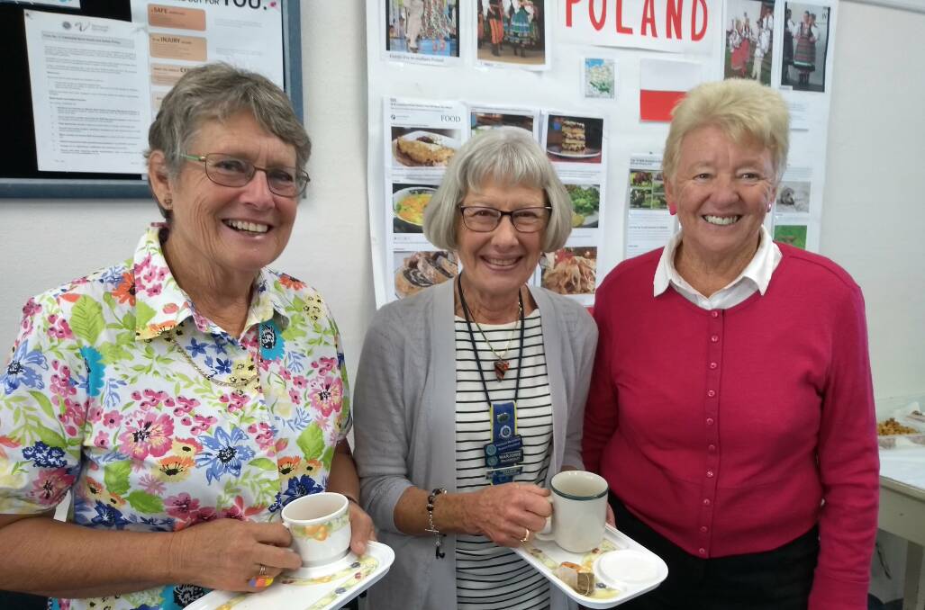 Joy Dawson, Marjorie MacKnight and Coralie Frew in front of the Polish poster. Poland is the country of study in 2018 for the CWA.