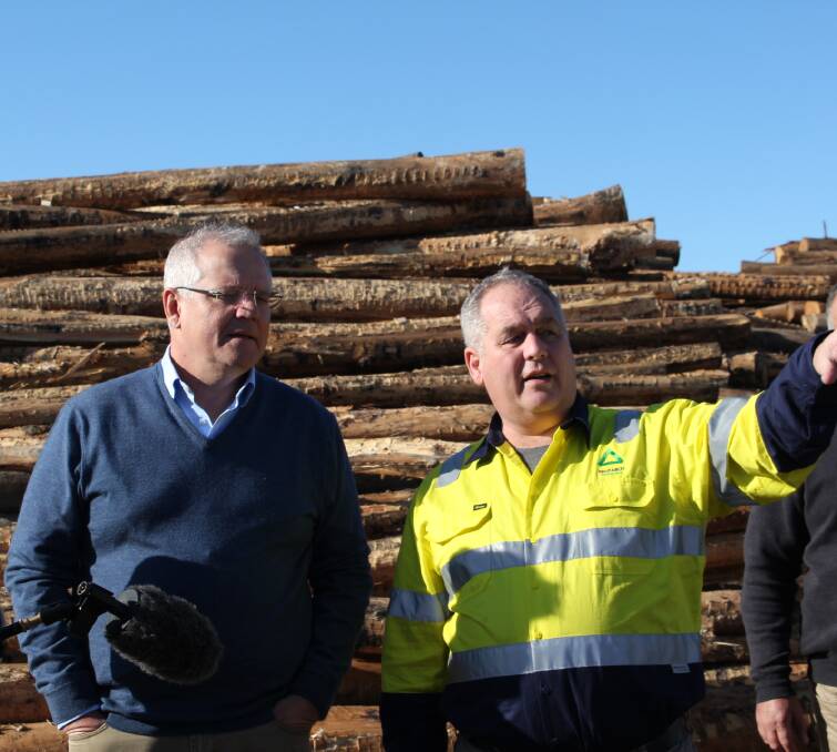The Prime Minister Scott Morrison talks with the chairman of Allied Natural Wood Exports Mal McComb during a visit to the Eden chip mill on Tuesday, June 23.